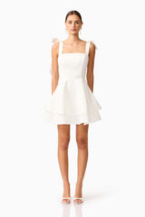 Brunette model wearing Livia Tiered Mini Dress in White front shot