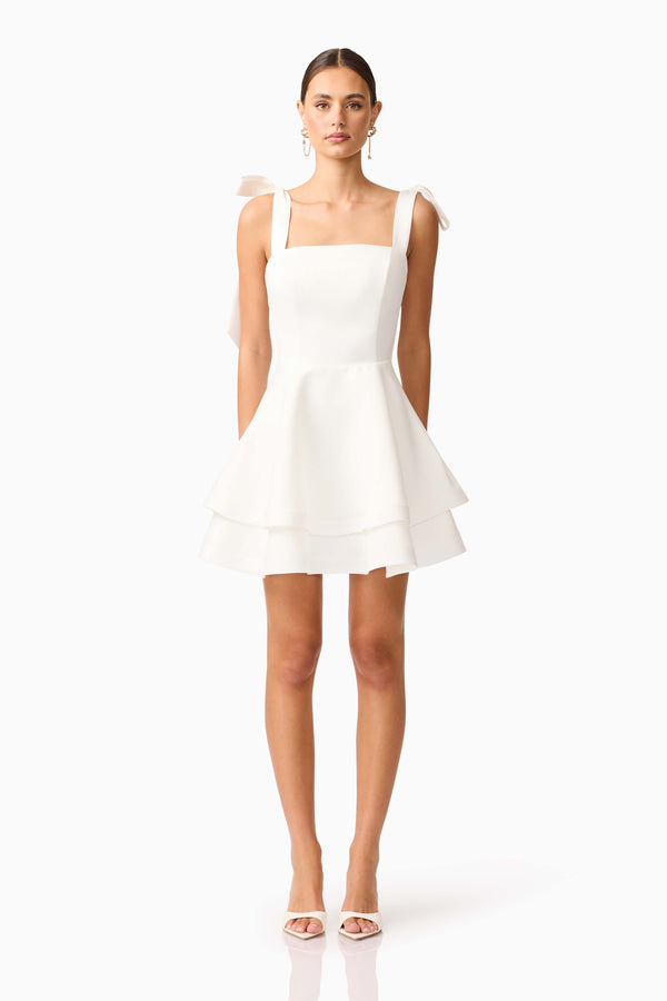 Brunette model wearing Livia Tiered Mini Dress in White front shot