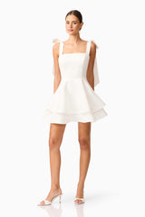 Brunette model wearing Livia Tiered Mini Dress in White posed shot