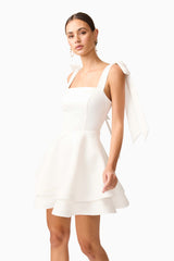Brunette model wearing Livia Tiered Mini Dress in White close up posed shot