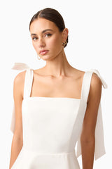 Brunette model wearing Livia Tiered Mini Dress in White close up shot