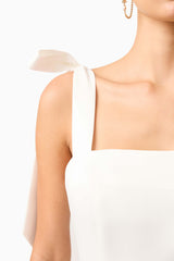 Brunette model wearing Livia Tiered Mini Dress in White detail shot