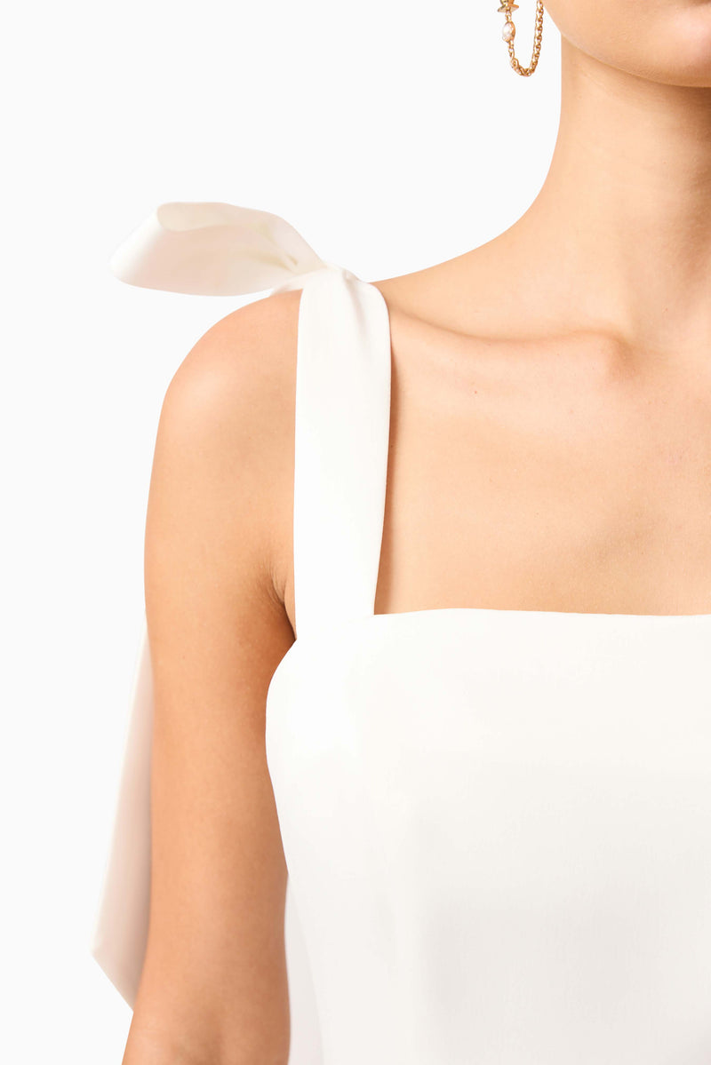Brunette model wearing Livia Tiered Mini Dress in White detail shot