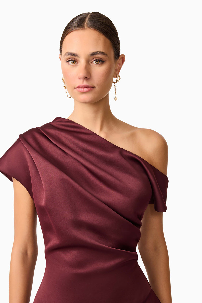 Brunette model wearing Livia Asymmetrical Gown in Red close up shot