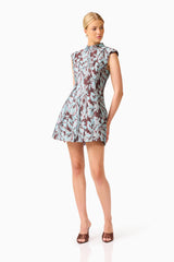 Bloomia Tulip Mini Dress in Brown & Blue Floral with a high neckline and sleeveless design posed shot