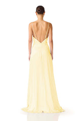 Brunette model wearing the Clementine Cowl Neck Gown in Butter Yellow back shot 