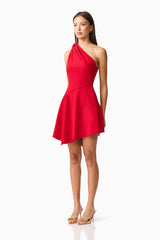 Brunette model wearing the Lila Asymmetrical Mini Dress in Red side shot