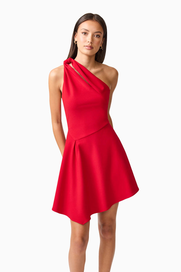 Brunette model wearing the Lila Asymmetrical Mini Dress in Red close up posed shot