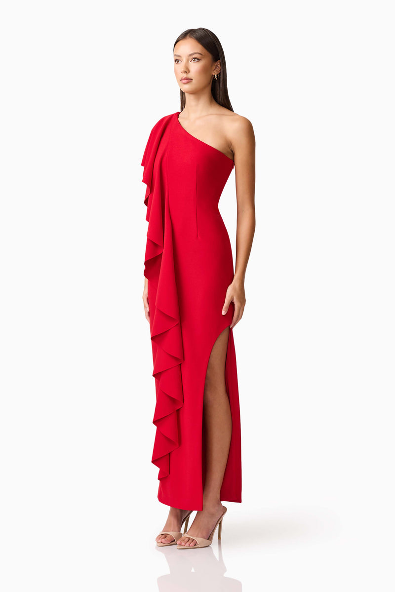 Brunette model wearing the Lila Asymmetrical Gown in Red side shot