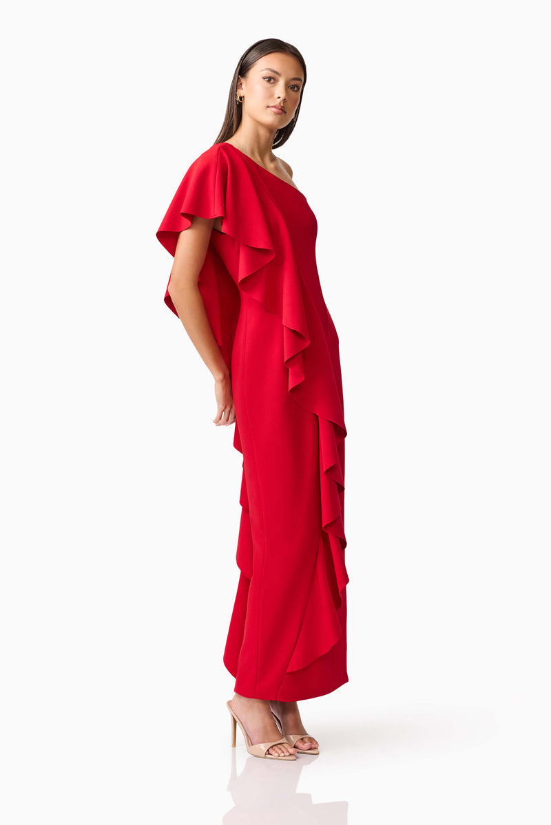 Brunette model wearing the Lila Asymmetrical Gown in Red posed shot