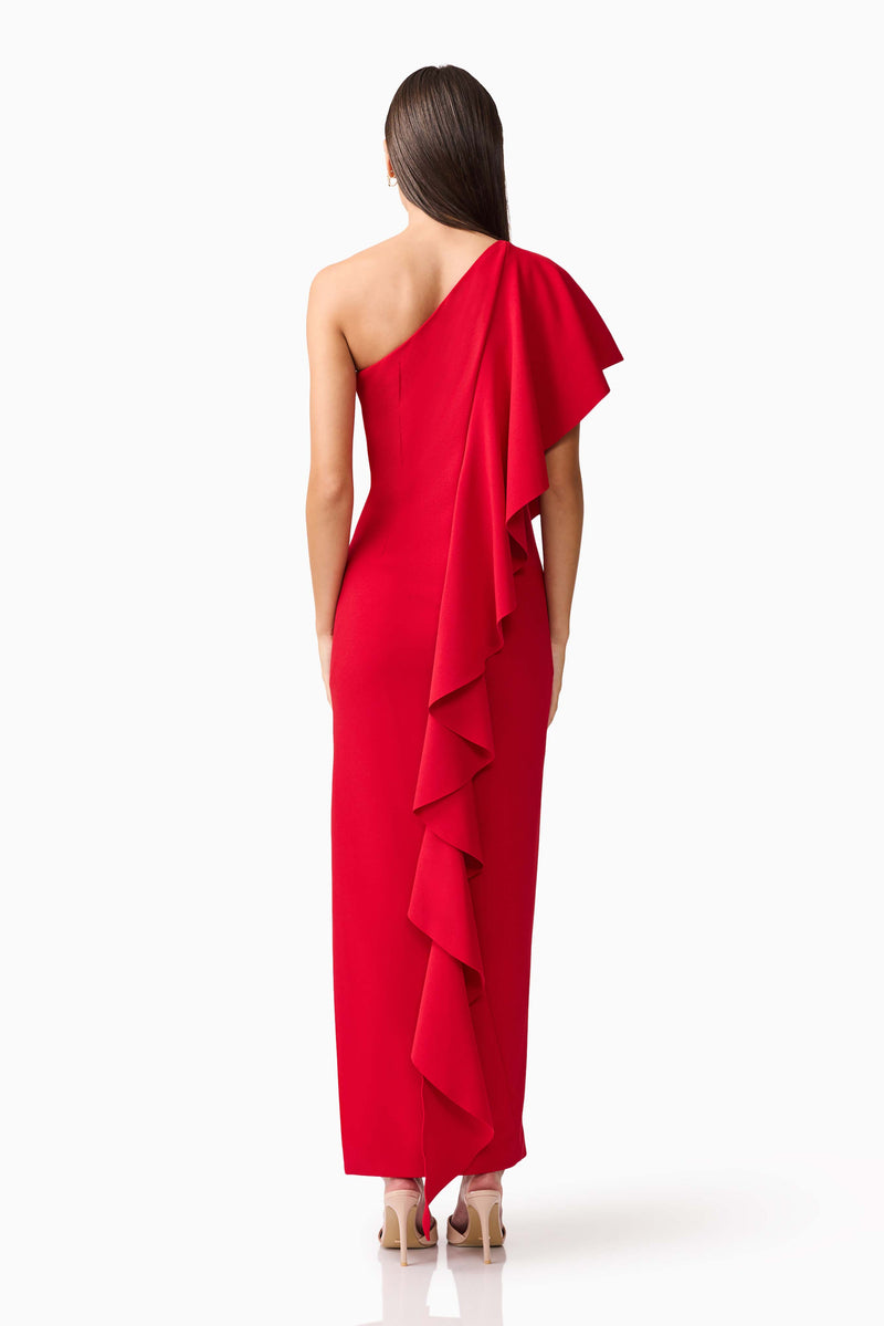 Brunette model wearing the Lila Asymmetrical Gown in Red back shot