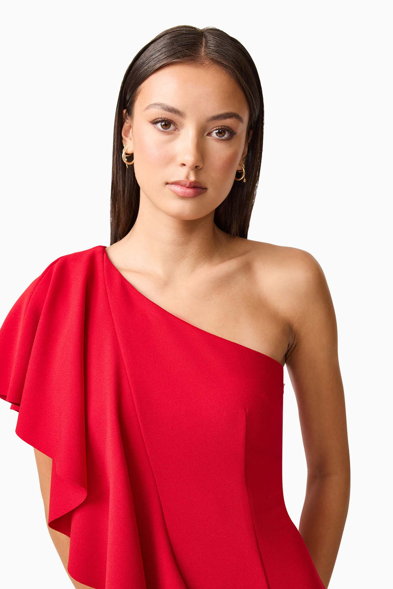 Brunette model wearing the Lila Asymmetrical Gown in Red detail shot