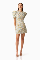 Brunette model wearing Tasmin Puff Sleeve Mini Dress in Blue & Yellow Floral Posed Shot
