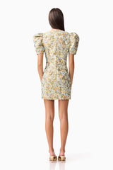 Brunette model wearing Tasmin Puff Sleeve Mini Dress in Blue & Yellow Floral Back Shot