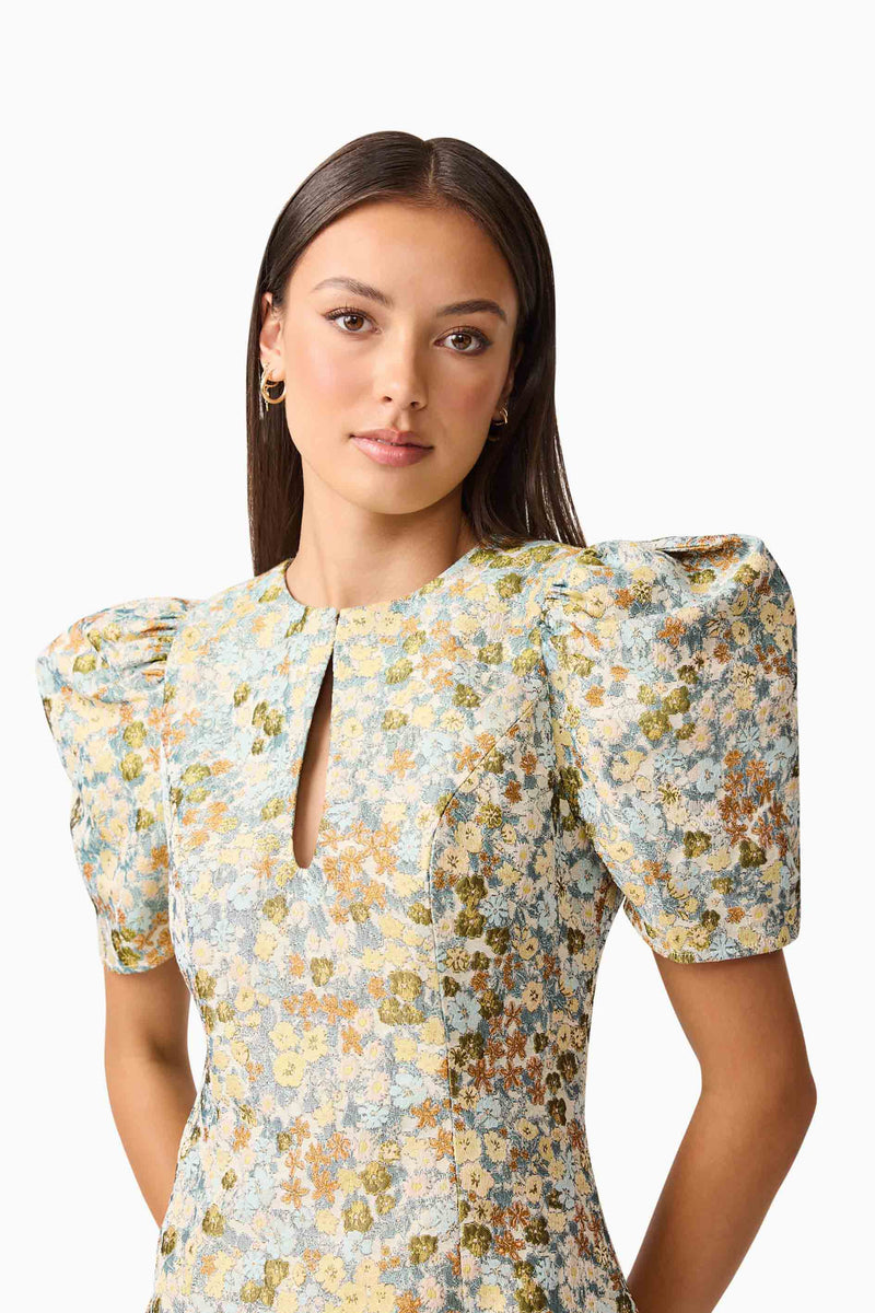 Brunette model wearing Tasmin Puff Sleeve Mini Dress in Blue & Yellow Floral Detail Shot