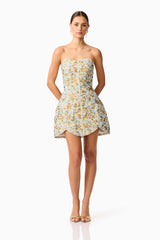 Brunette model wearing Tasmin Strapless Mini Dress in Blue & Yellow Floral posed shot 