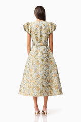 Brunette model wearing Tasmin Puff Sleeve Midi Dress in Blue & Yellow Floral back Shot