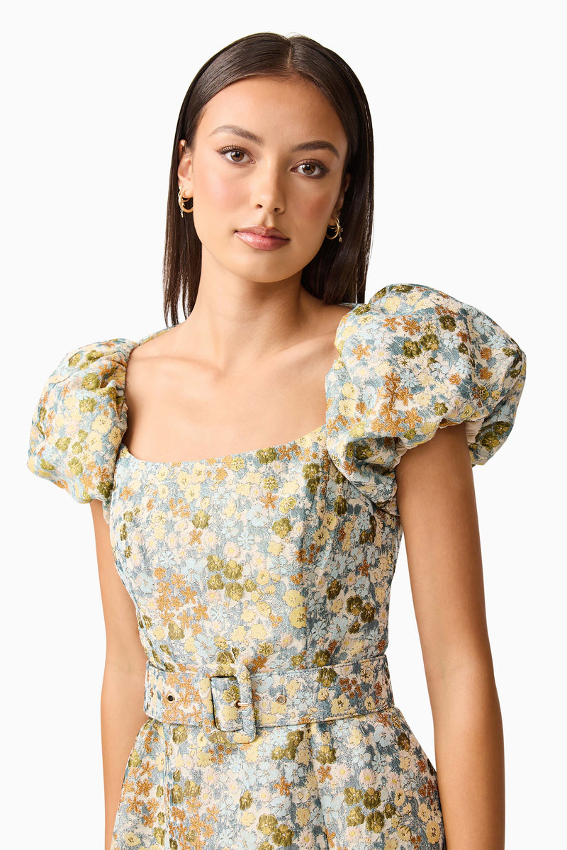 Brunette model wearing Tasmin Puff Sleeve Midi Dress in Blue & Yellow Floral detail Shot