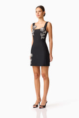 Brunette model wearing the Soleil Party Mini Dress in Black side shot