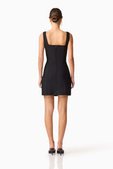 Brunette model wearing the Soleil Party Mini Dress in Black back shot