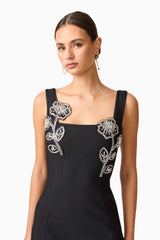Brunette model wearing the Soleil Party Mini Dress in Black close up shot