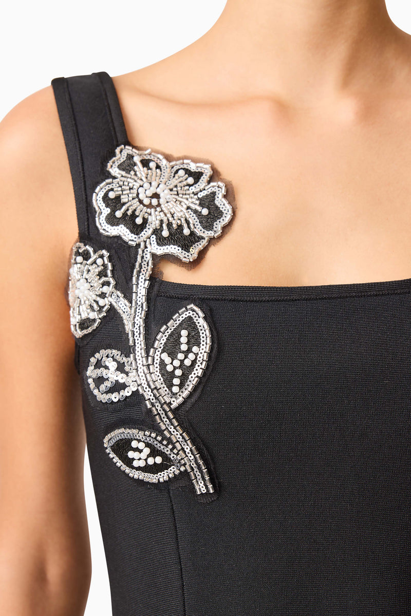 Brunette model wearing the Soleil Party Mini Dress in Black detail shot