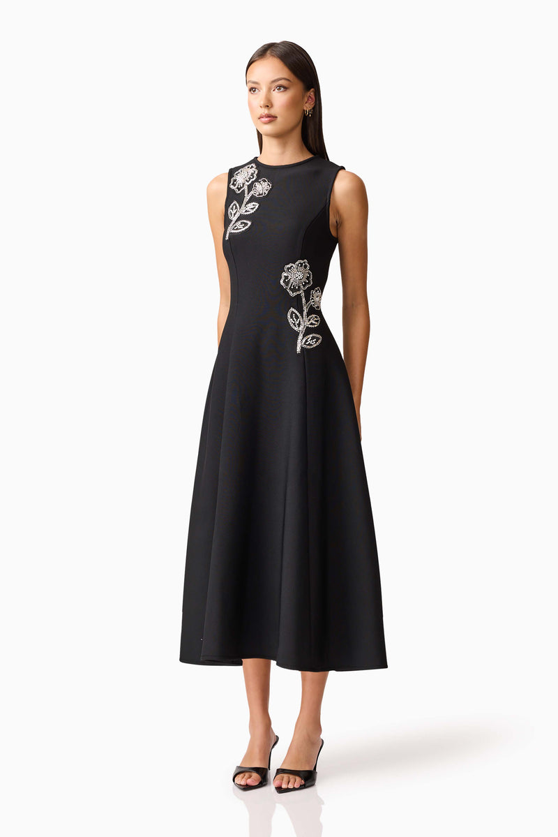Brunette model wearing the Soleil A-Line Midi Dress in Black Side Shot
