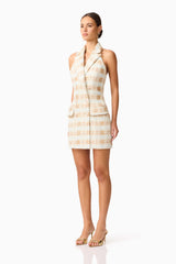 Brunette model wearing Ashlyn Halter Tweed Mini Dress in White & Gold side shot