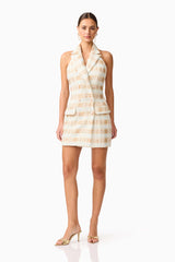 Brunette model wearing Ashlyn Halter Tweed Mini Dress in White & Gold posed shot