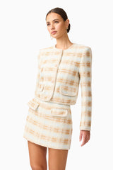 Brunette model wearing the Ashlyn Tweed Jacket in Gold & White close up shot