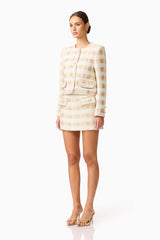 Brunette model wearing Ashlyn Long Sleeve Tweed Set in White & Gold side shot