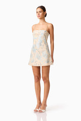 Brunette model wearing Nia Embroidered Mini Dress in Beige side Shot