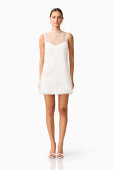 Brunette model wearing the Margot Party Shift Mini Dress in White front shot