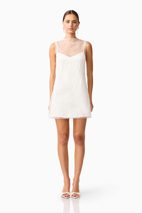 Brunette model wearing the Margot Party Shift Mini Dress in White front shot