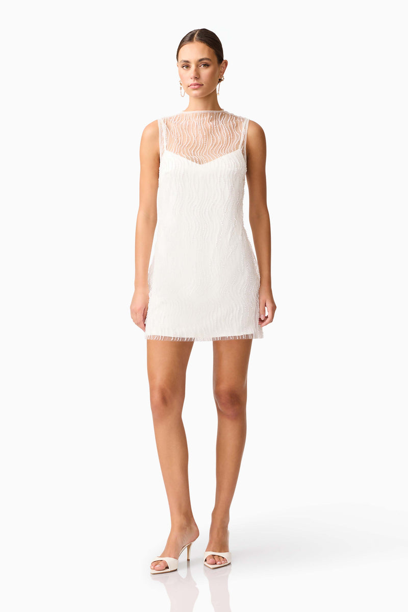 Brunette model wearing the Margot Party Shift Mini Dress in White posed shot