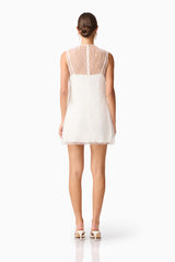Brunette model wearing the Margot Party Shift Mini Dress in White back shot