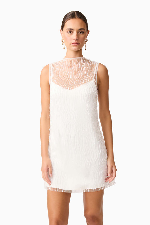 Brunette model wearing the Margot Party Shift Mini Dress in White close up shot