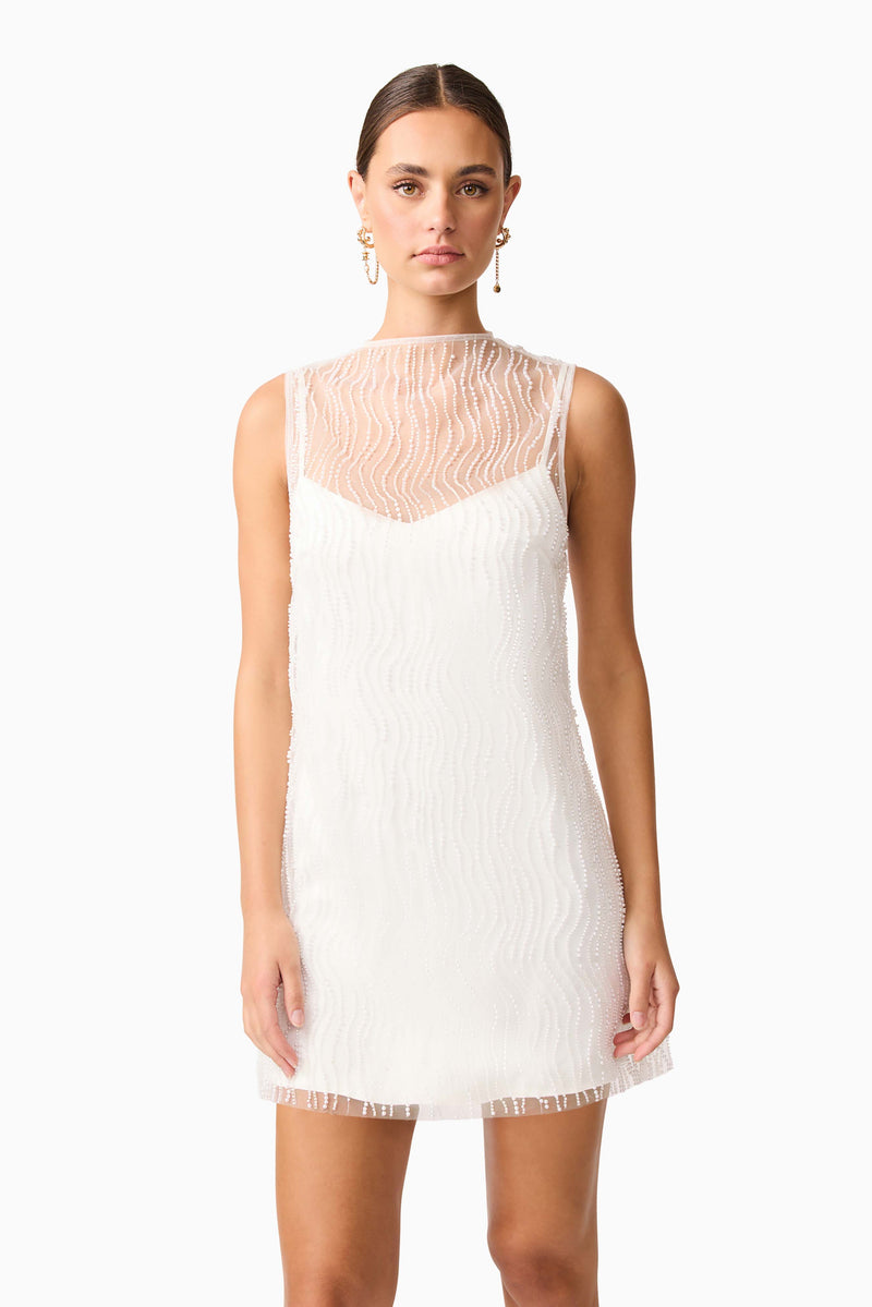 Brunette model wearing the Margot Party Shift Mini Dress in White close up shot