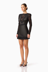 Brunette model wearing the Margot Long Sleeve Mini Dress in Black Side shot
