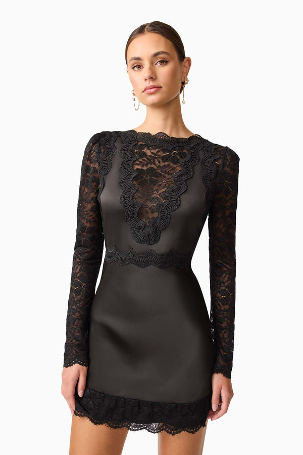 Brunette model wearing the Margot Long Sleeve Mini Dress in Black Close Up shot