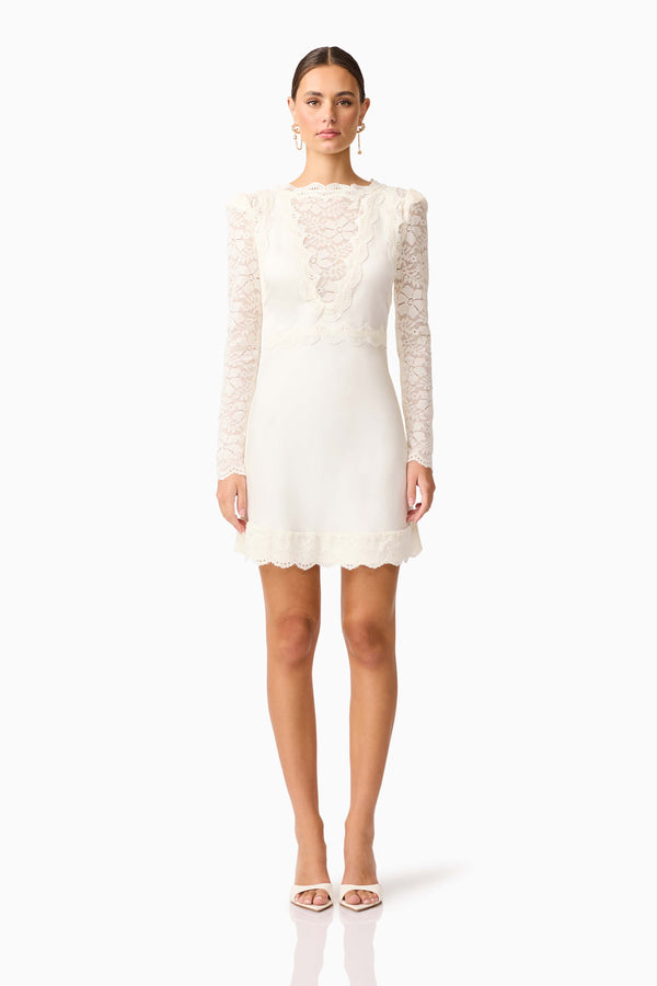 Brunette model wearing the Margot Long Sleeve Mini Dress in White front shot