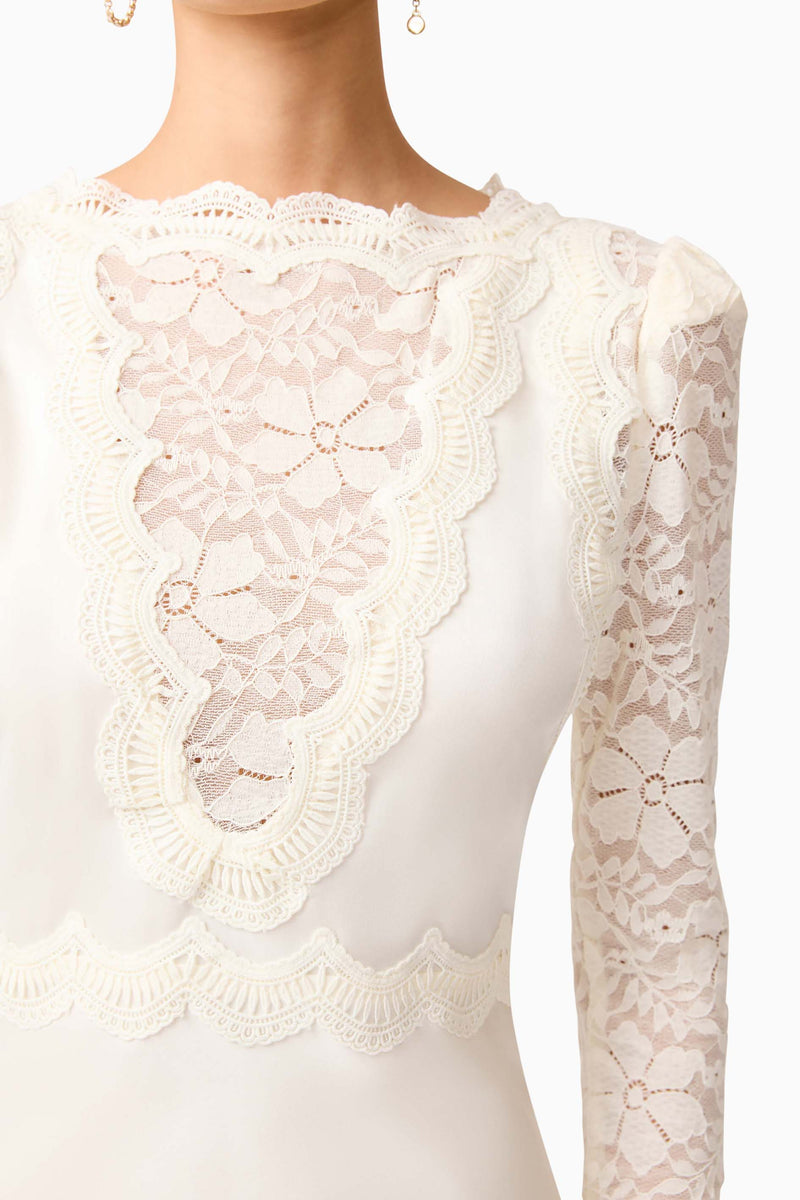 Brunette model wearing the Margot Long Sleeve Mini Dress in White detail shot