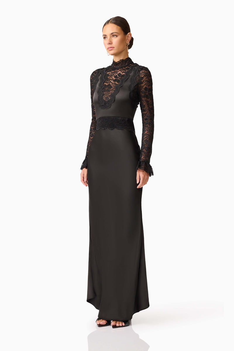 Brunette model wearing the Margot Long Sleeve Gown in Black side shot