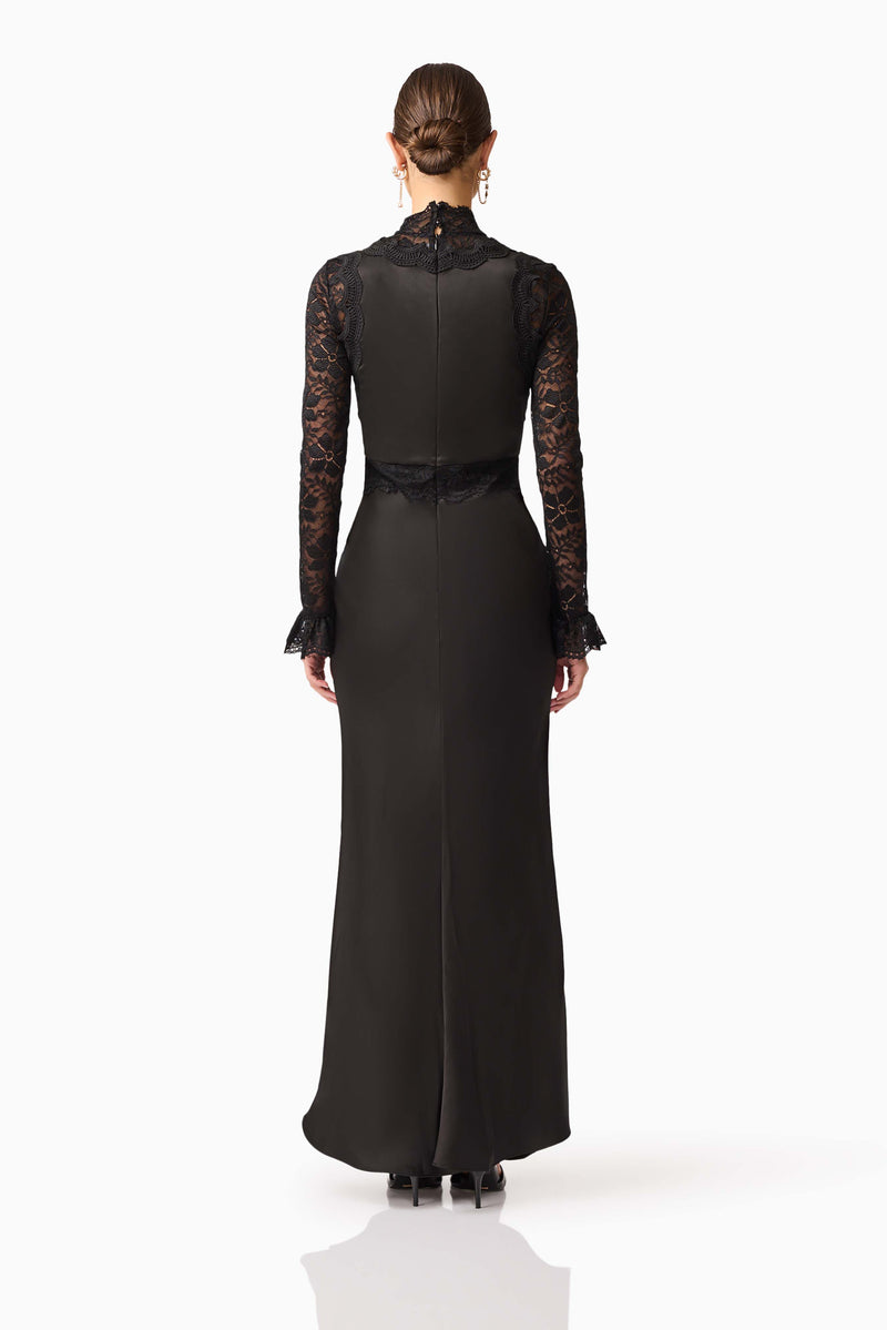 Brunette model wearing the Margot Long Sleeve Gown in Black back shot