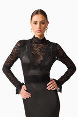 Brunette model wearing the Margot Long Sleeve Gown in Black close up posed shot