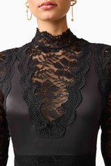 Brunette model wearing the Margot Long Sleeve Gown in Black detail shot