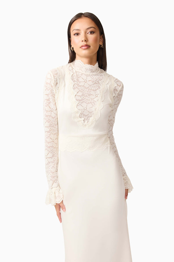 Brunette model wearing the Margot Long Sleeve Gown in White close up posed shot
