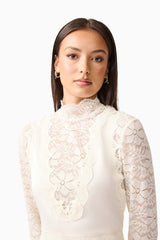 Brunette model wearing the Margot Long Sleeve Gown in White close up shot