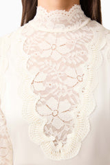 Brunette model wearing the Margot Long Sleeve Gown in White detail shot