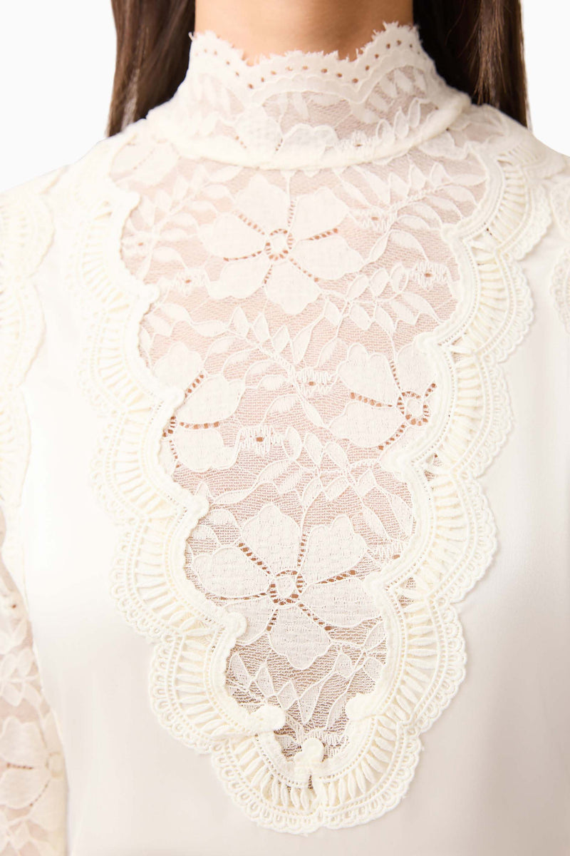 Brunette model wearing the Margot Long Sleeve Gown in White detail shot